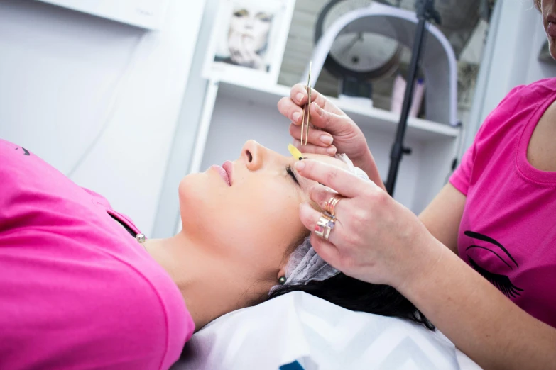 a woman getting her eyebrows done at a beauty salon, by Julian Allen, ultradetail face, fan favorite, gelbooru, lying down