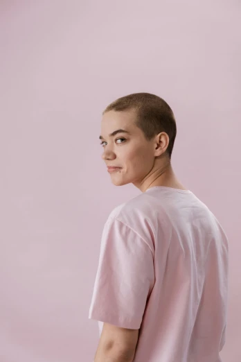 a man standing in front of a pink background, by Anna Füssli, trending on unsplash, pixie cut with shaved side hair, teenage girl, beautifully daylight, portrait sophie mudd
