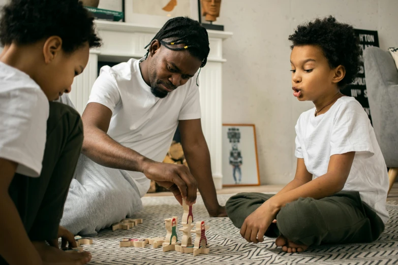 a father plays with his children on the floor, pexels contest winner, board games, afrocentric mysticism, high quality screenshot, profile pic