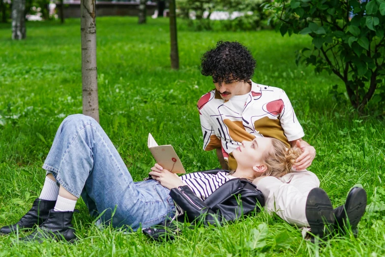 a couple of people that are laying in the grass, holding a book, profile image, full body image, trending photo