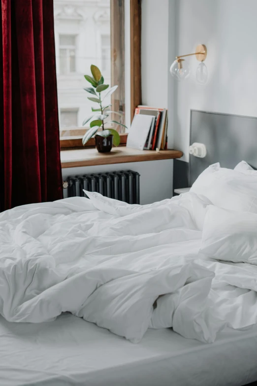 a white bed sitting in a bedroom next to a window, by Adam Marczyński, banner, multiple stories, cleanest image, bedhead