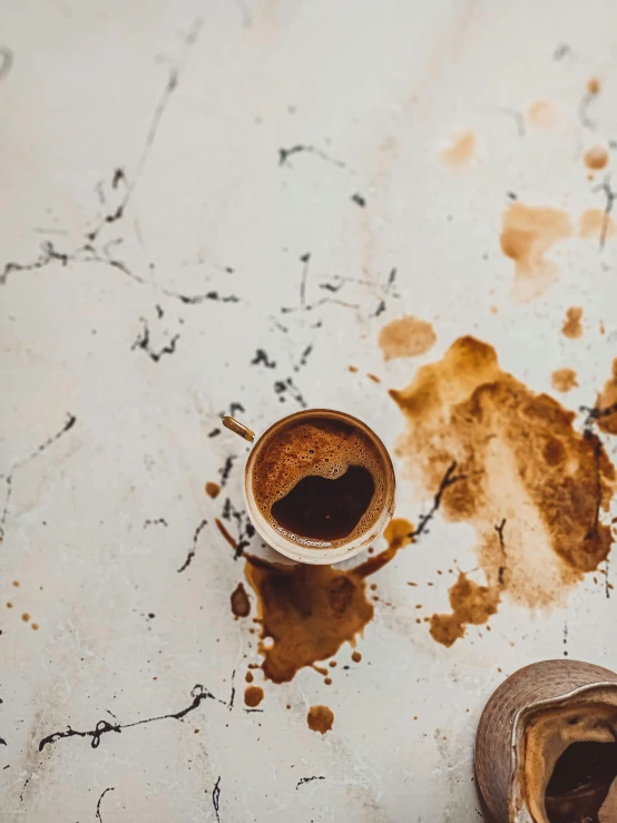 a couple of cups of coffee sitting on top of a table, splattered tar, profile image, while marble, trending photo