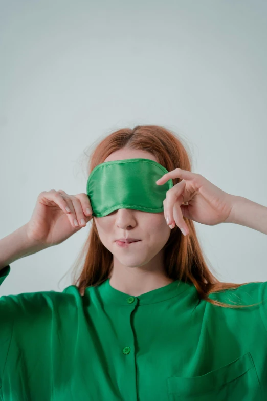 a woman with a green blindfold covering her eyes, trending on pexels, wearing pajamas, sadie sink, green lantern, sustainability