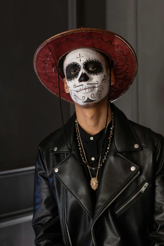 a man with a skull face painted on his face, an album cover, trending on pexels, sombrero, playboi carti, gregg araki, masterpiece costume