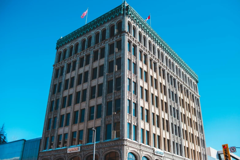 a tall building sitting on the corner of a street, unsplash, art nouveau, tucson arizona, square, office building, hasui kwase