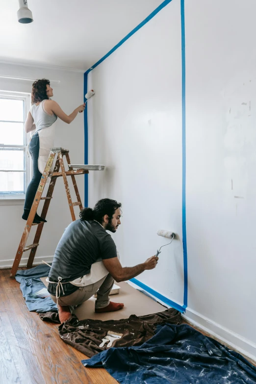 a couple of people that are painting a wall, trending on pexels, arbeitsrat für kunst, zillow interior, 🚿🗝📝