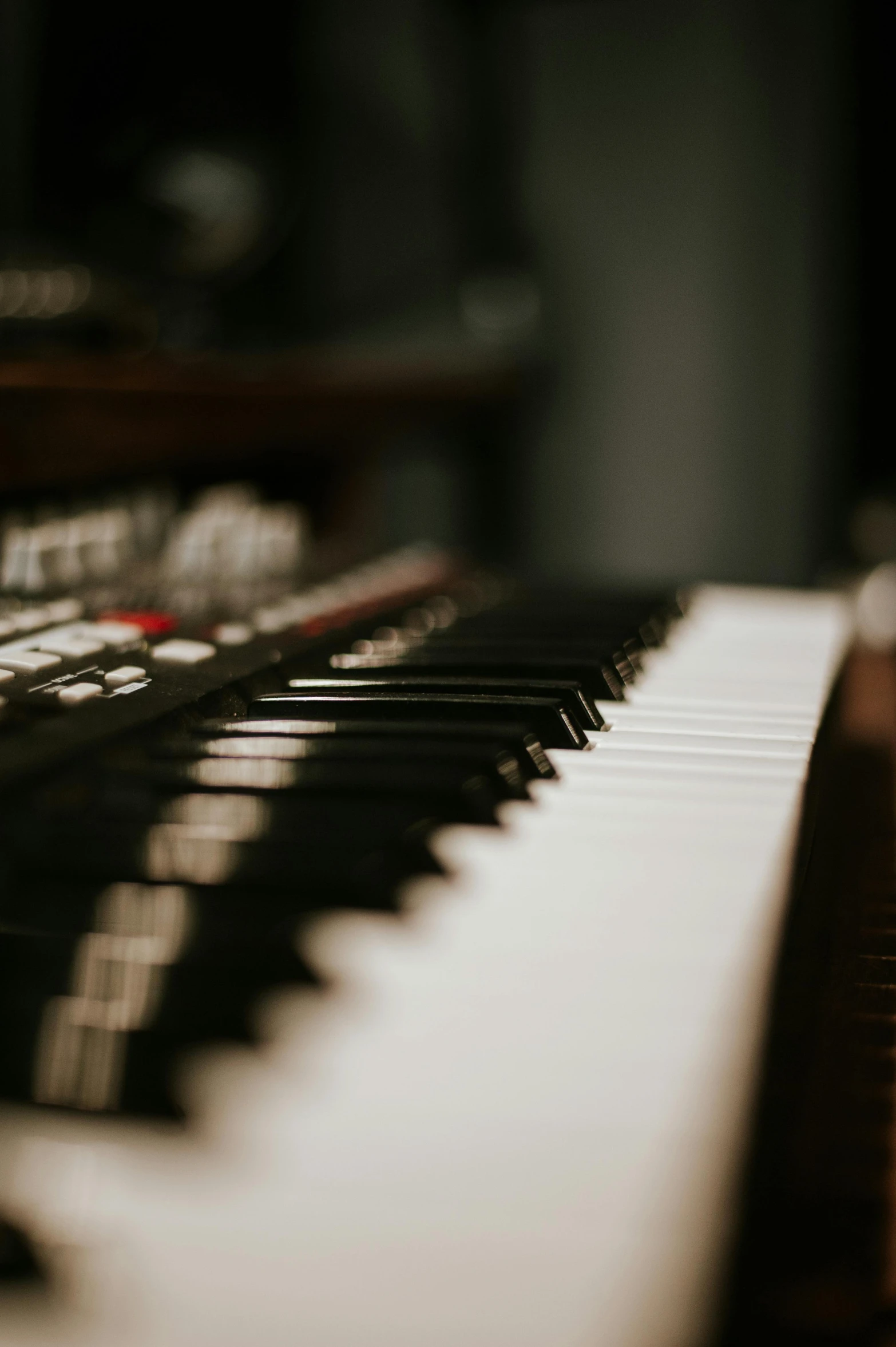 a close up of a keyboard in a room, an album cover, inspired by Bryan Organ, unsplash, soft light - n 9, sydney hanson, music instruments, studio picture