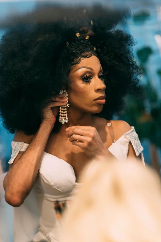a woman that is standing in front of a mirror, an album cover, trending on pexels, renaissance, ru paul\'s drag race, wedding, black elegant hair, ☁🌪🌙👩🏾