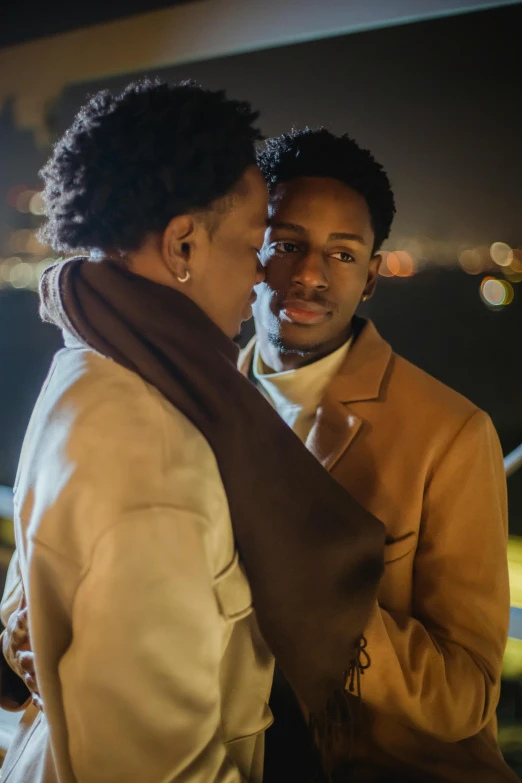 a man and a woman standing next to each other, trending on pexels, romanticism, 2 1 savage, brown tuffle coat, two men hugging, candlelit