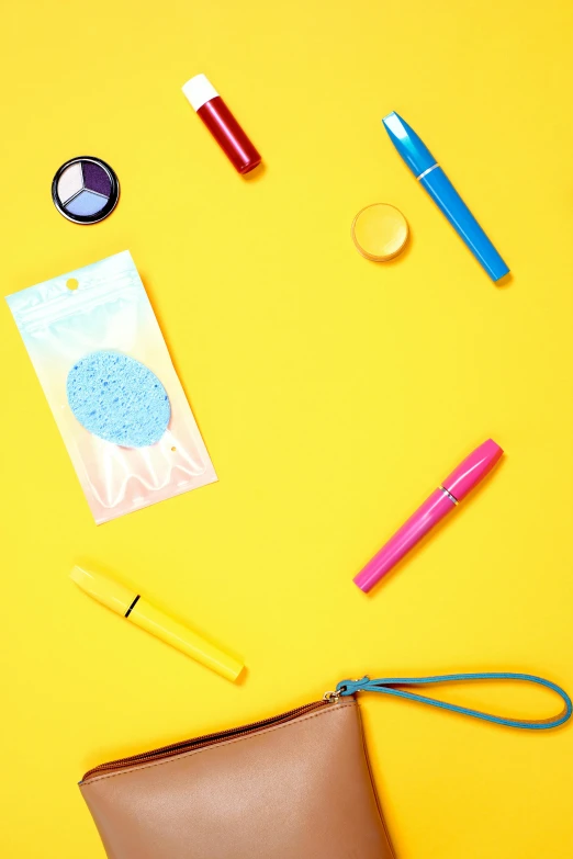 a brown purse sitting on top of a yellow surface, by Julia Pishtar, trending on pexels, pop art, pastel makeup, neon blue color, knolling, crayon