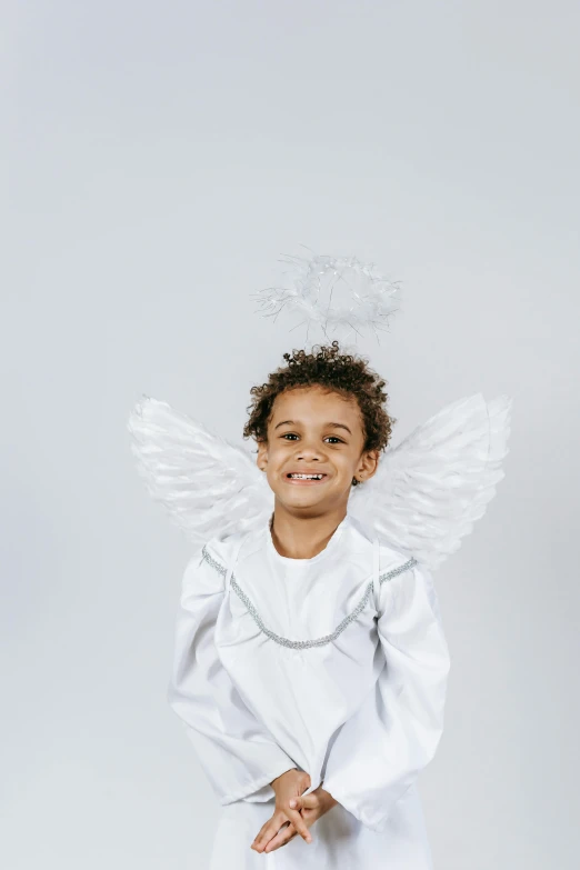 a little boy dressed up as an angel, pexels contest winner, plain background, african american girl, white shiny skin, white cloud hair