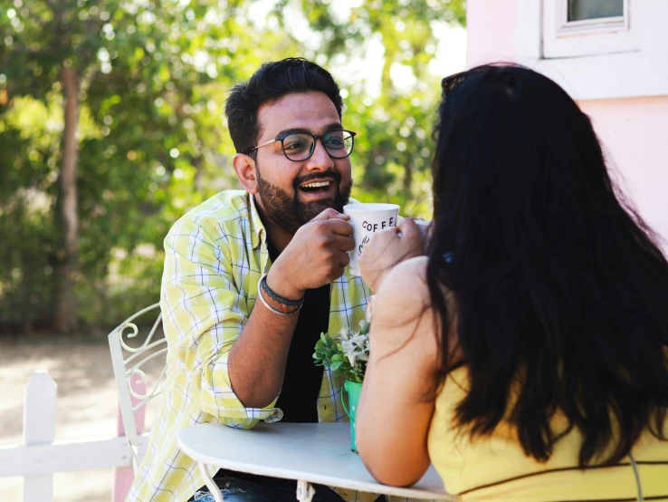 a man and a woman sitting at a table, pexels contest winner, happening, vinayak, flirting smiling, avatar image, eating ice - cream