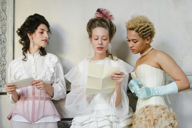 a group of three women standing next to each other, inspired by Jean-Étienne Liotard, pexels, rococo, writing a letter, in style of cecil beaton, white, victorian inspired clothing