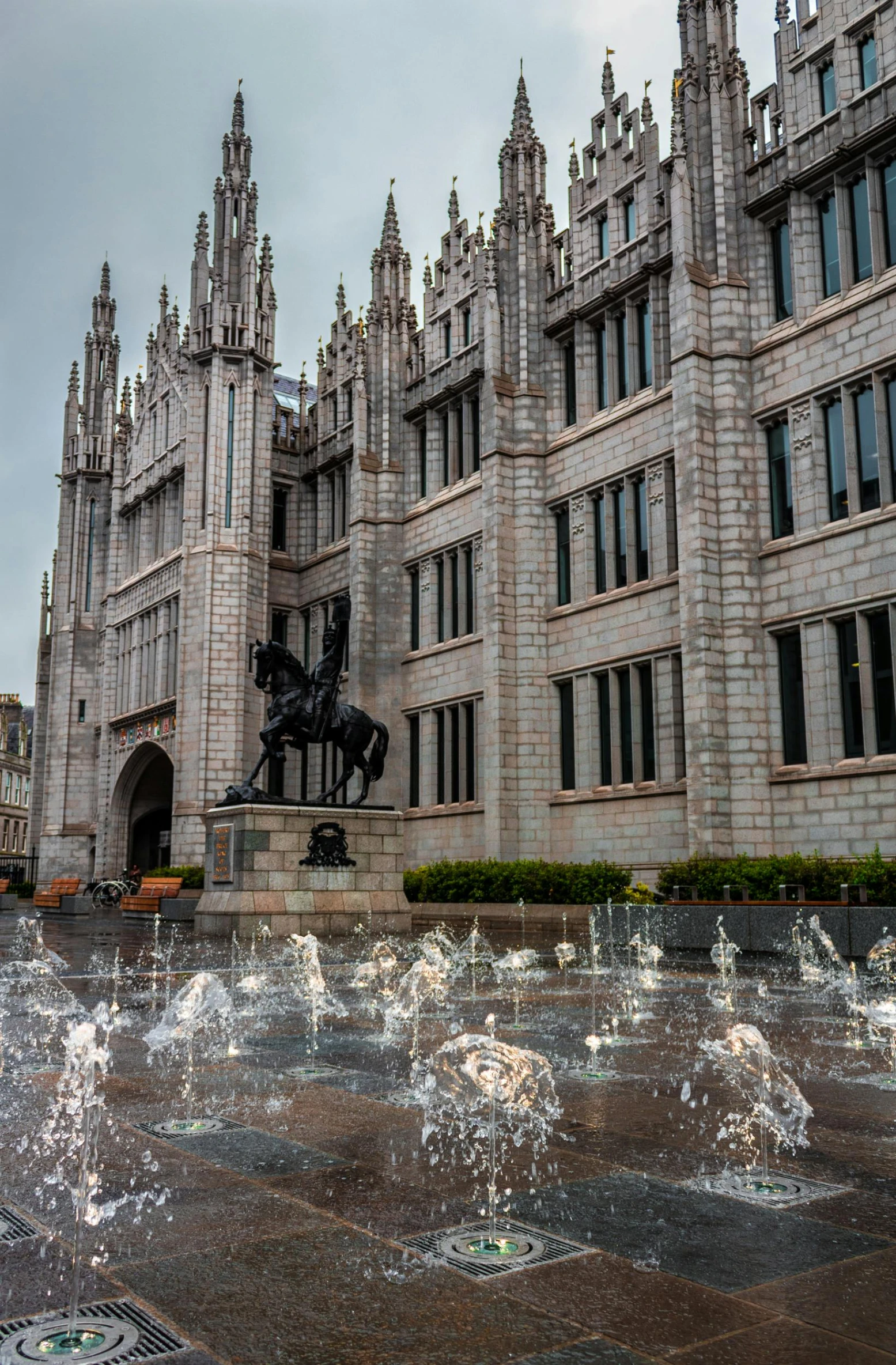 a large building with a fountain in front of it, a statue, inspired by Master of Saint Giles, visual art, in scotland, spines and towers, high-quality photo, trending photo