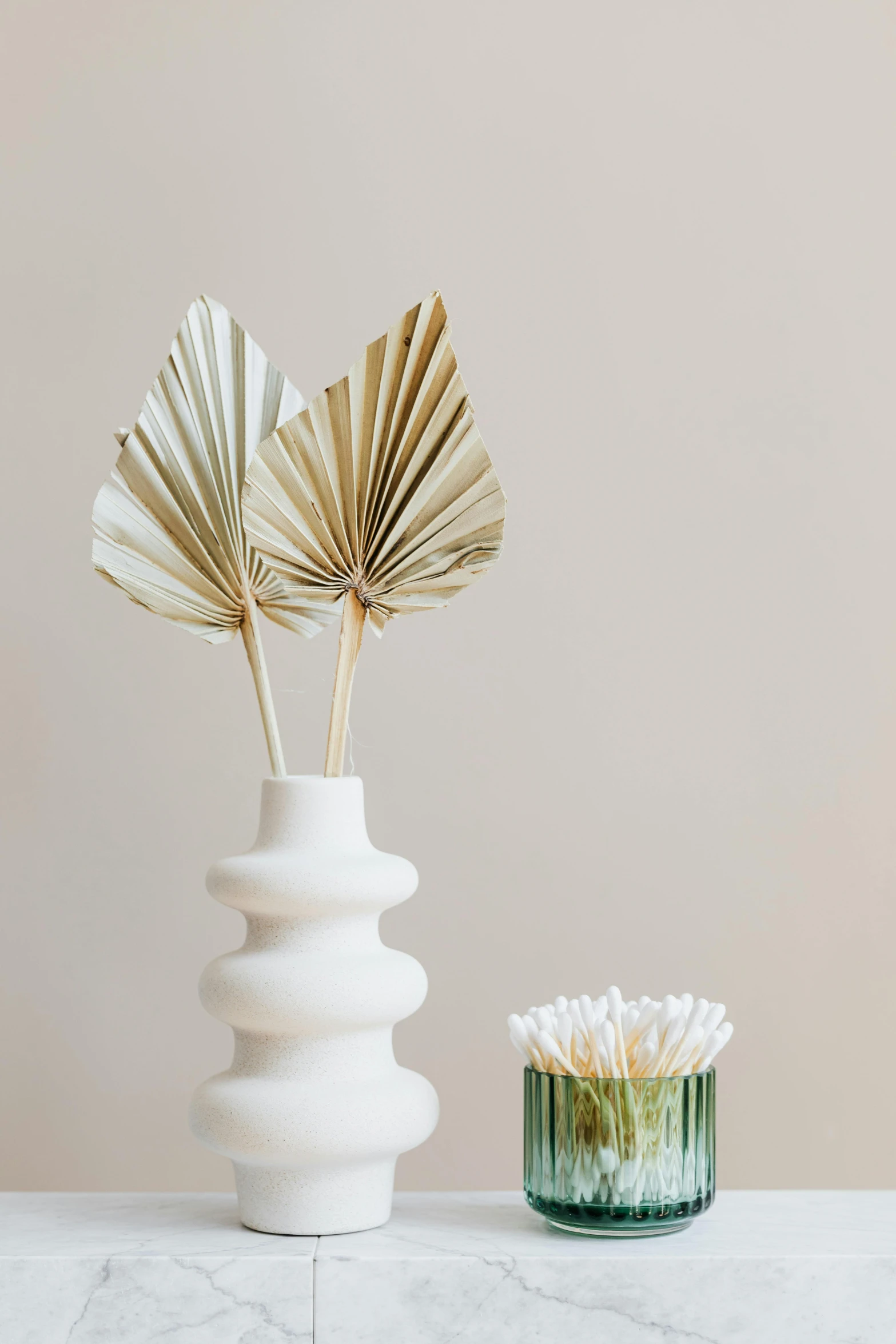 a couple of vases sitting on top of a table, fronds, cream paper, collection product, spears