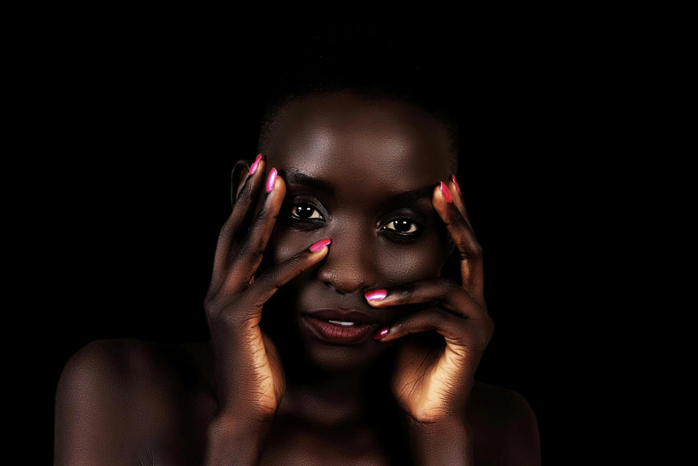 a woman with her hands on her face, by Lily Delissa Joseph, pexels contest winner, brown and magenta color scheme, pitch black skin, painted nails, light eyes