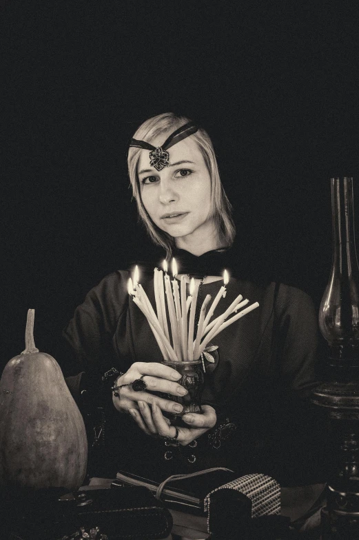 a black and white photo of a woman holding candles, a black and white photo, inspired by Claude Cahun, unsplash, renaissance, portrait female elf wizard, anna nikonova aka newmilky, she is a gourd, similar to malfoy