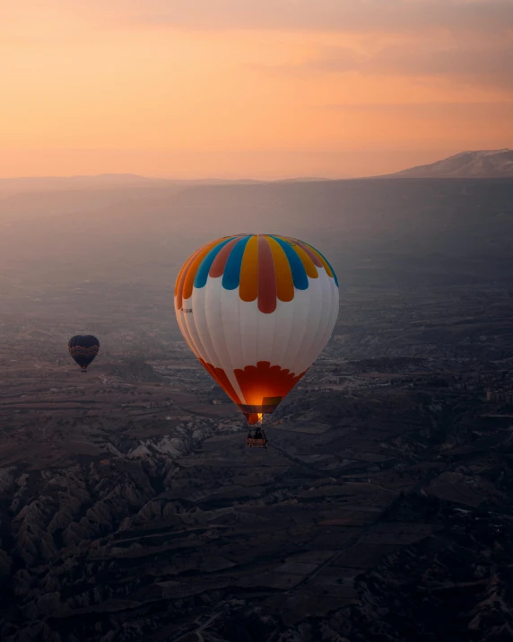 a couple of hot air balloons flying in the sky, by irakli nadar, pexels contest winner, overlooking a valley, lgbt, in muted colors, helmet is off