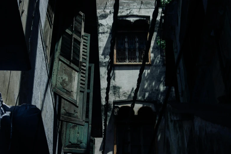 a person walking down a narrow alley way, a detailed matte painting, bengal school of art, with ominous shadows, old color photograph, [ cinematic, open windows