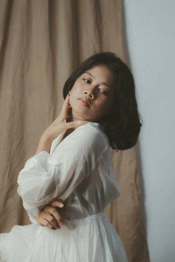 a woman in a white dress posing for a picture, an album cover, by Basuki Abdullah, pexels contest winner, realism, cream colored blouse, medium format. soft light, ((portrait)), indoor picture