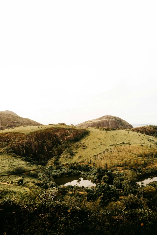 a man flying a kite on top of a lush green hillside, by Lucas Vorsterman, trending on unsplash, les nabis, madagascar, 4 k cinematic panoramic view, near a small lake, sydney park