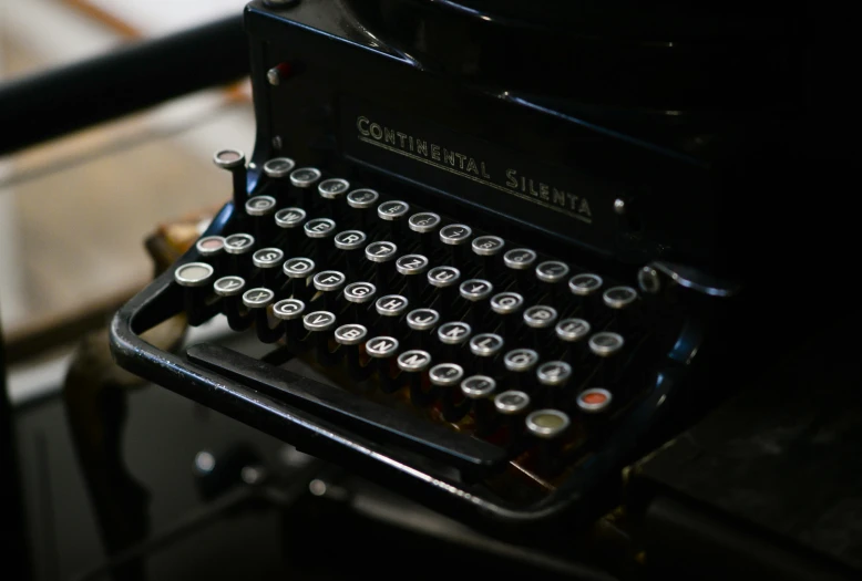 a black typewriter sitting on top of a table, by Sylvia Wishart, unsplash, multiple stories, fan favorite, preserved historical, serena malyon