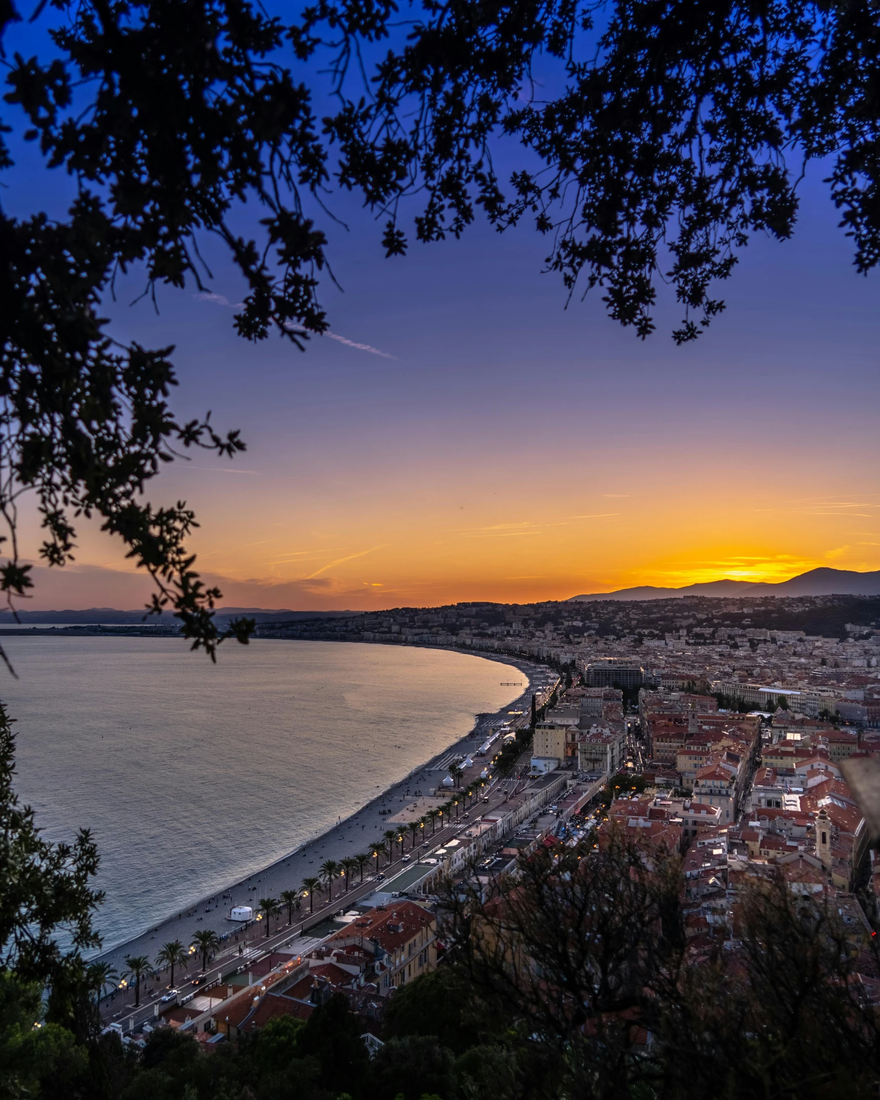 a view of a city from the top of a hill, a picture, pexels contest winner, renaissance, which shows a beach at sunset, nice, traveling in france, twilight ; wide shot