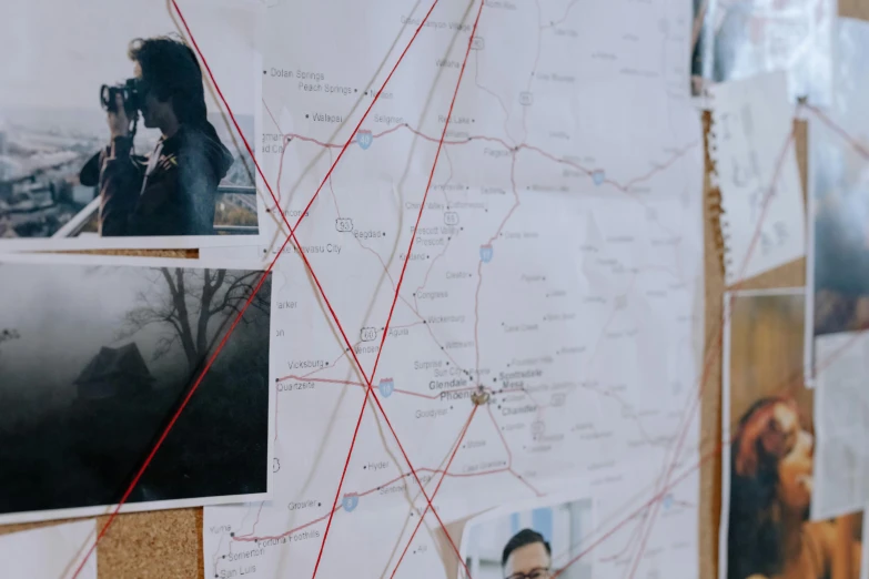 a cork board with a bunch of pictures on it, by Caroline Mytinger, trending on pexels, serial art, true detective, focus on map, connecting lines, 3 / 4 wide shot