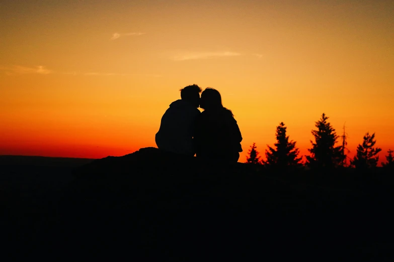 a couple sitting on top of a hill at sunset, pexels, romanticism, making out, silhouette :7, profile image, colored photo