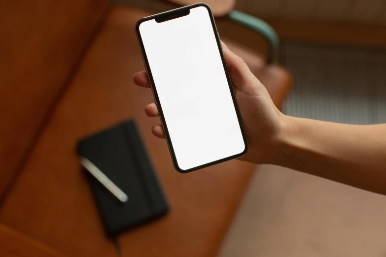 a close up of a person holding a cell phone, a picture, on a desk, no - text no - logo, iphone wallpaper, rectangle