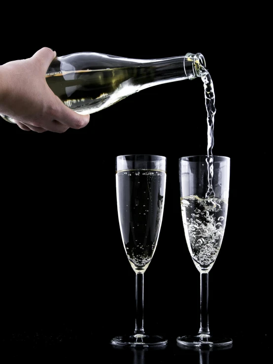 a person pouring wine into two glasses, happening, bubbles ”, february)