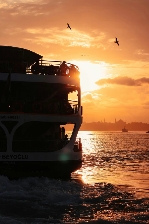 a large boat traveling across a body of water, by Niyazi Selimoglu, hurufiyya, watching the sunset, istanbul, slide show, multiple stories