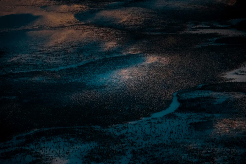 a large body of water sitting on top of a sandy beach, an album cover, unsplash contest winner, tonalism, aerial photo night vision, river delta, midnight-blue, textured like a carpet