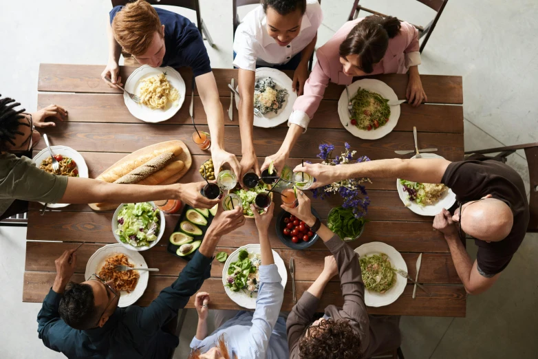 a group of people sitting at a table with plates of food, by Carey Morris, pexels contest winner, renaissance, avatar image, environmental shot, having fun, hands pressed together in bow