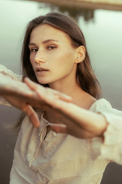 a woman reaching out to catch a frisbee, an album cover, by Emma Andijewska, trending on pexels, renaissance, gal gadot portrait, delicate soft hazy lighting, looking serious, tai chi