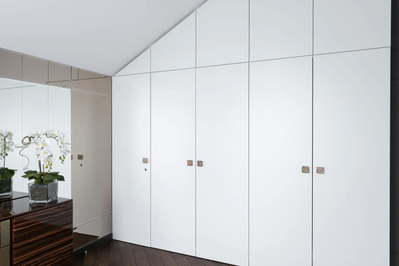 a mirror sitting on top of a dresser in a room, inspired by Richard Wilson, bauhaus, lockers, with matte white angled ceiling, titanium white, no - text no - logo