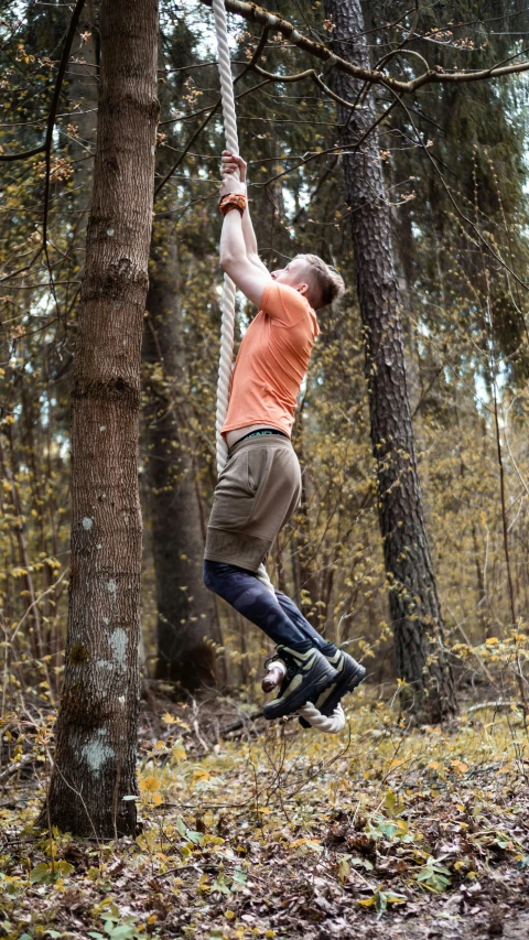 a man hanging from a rope in the woods, by Caspar Wolf, unsplash, hurufiyya, working out in the field, kneehigh boots, 15081959 21121991 01012000 4k, nina tryggvadottir