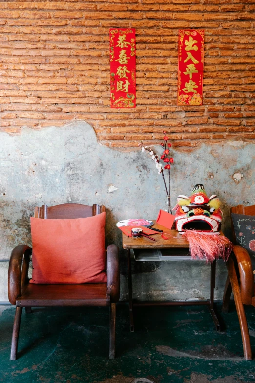 a couple of chairs sitting next to each other, a portrait, inspired by Cui Bai, trending on unsplash, red adornments, rustic setting, conde nast traveler photo, color image