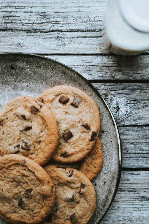 a plate of chocolate chip cookies next to a glass of milk, a still life, unsplash, high quality product image”, sunlit, 6 pack, kek