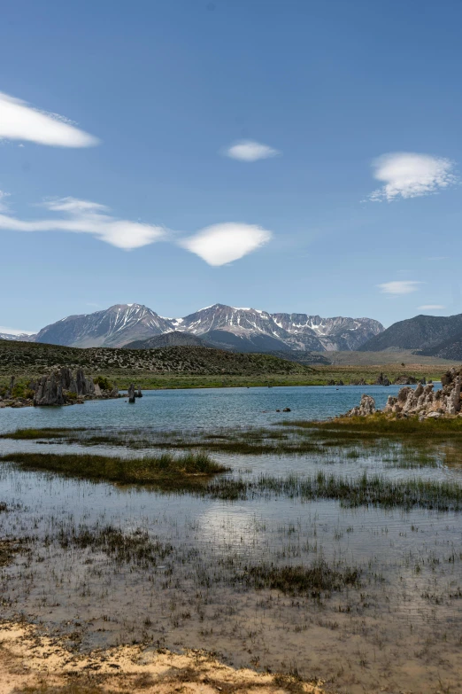 a body of water with mountains in the background, les nabis, mammoth, marsh, wide views, van