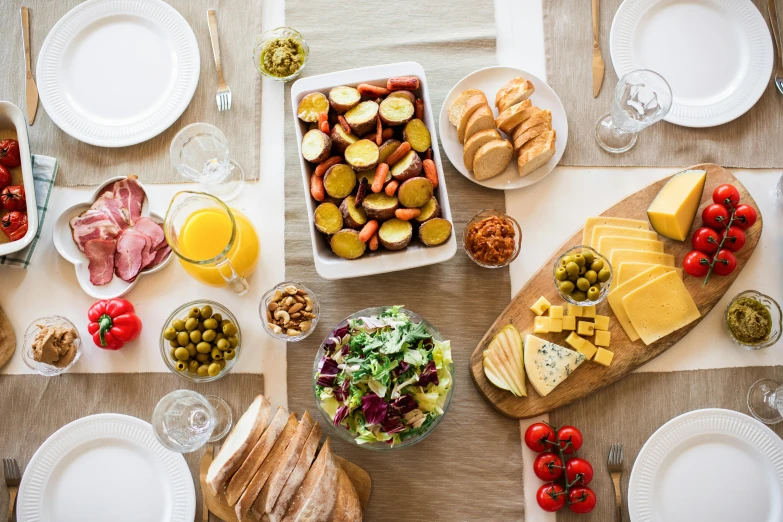 a wooden table topped with plates of food, by Carey Morris, pexels contest winner, fan favorite, swedish, group photo, split near the left