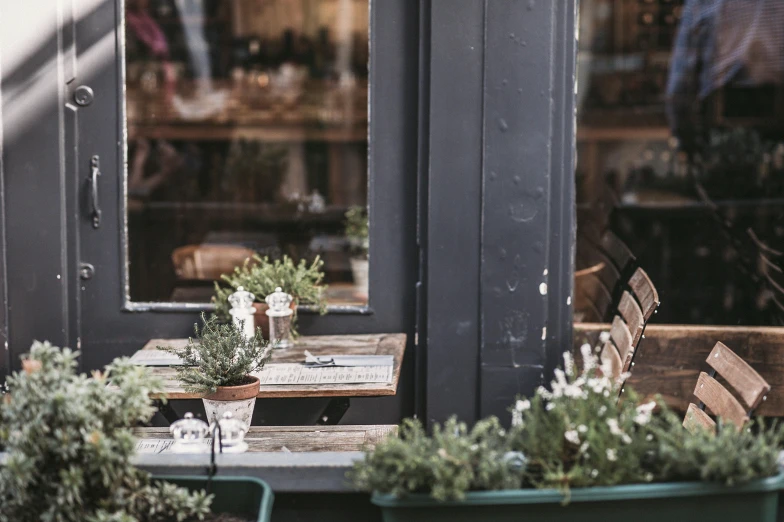 a table and chairs outside of a restaurant, by Emma Andijewska, trending on unsplash, lots of jars and boxes of herbs, windowsill, seasonal, pierre pellegrini and ash thorp