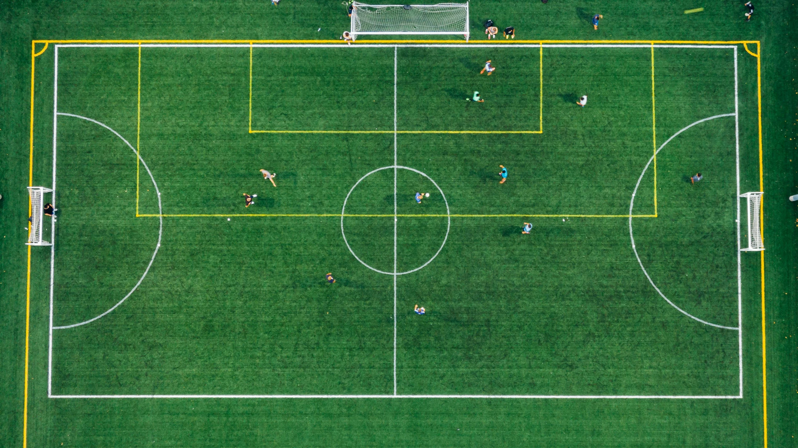 a group of people playing a game of soccer, by Carey Morris, pexels contest winner, conceptual art, helicopter view, lush green, minimalist, large format