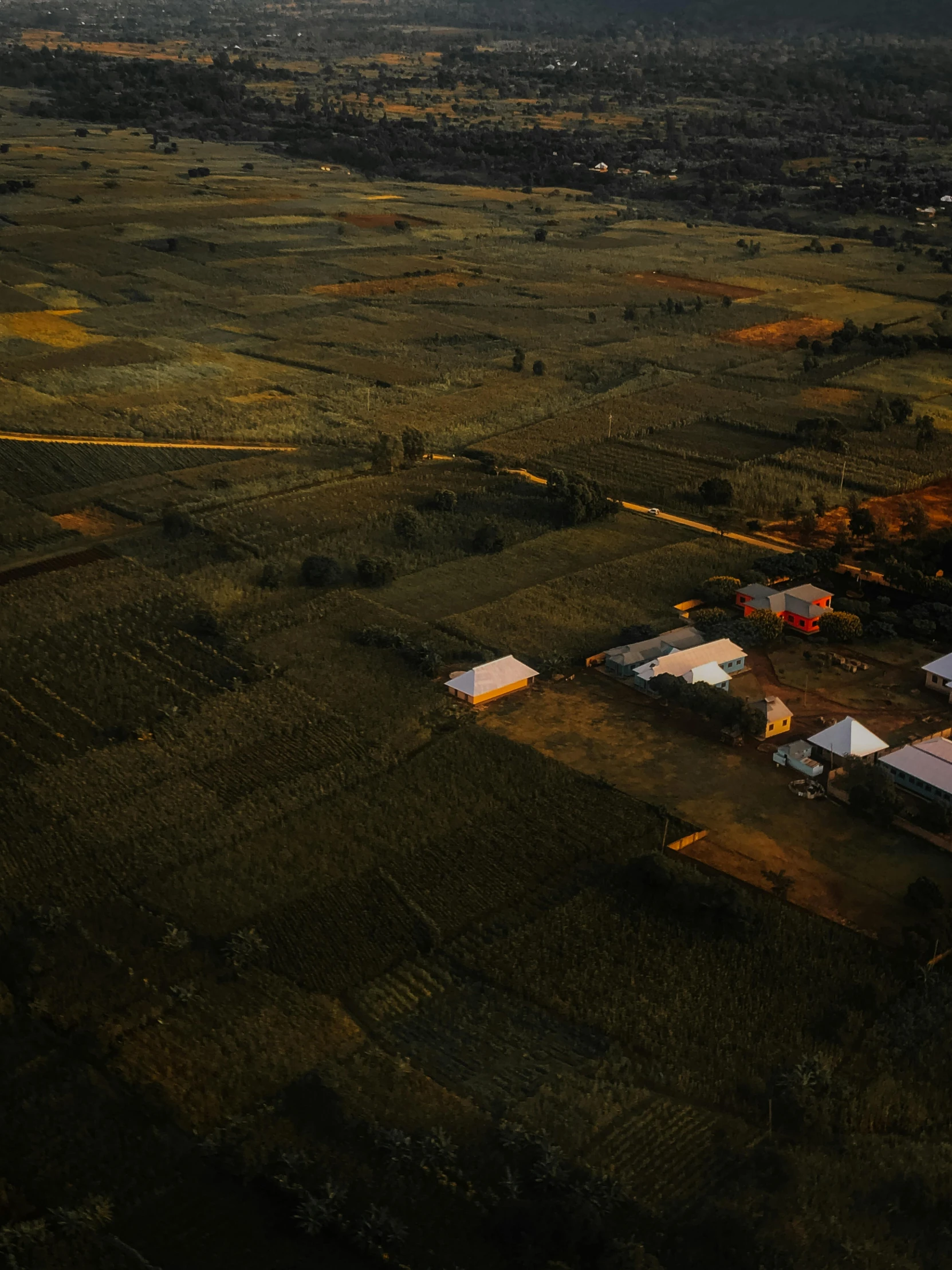 an aerial view of a farm in a rural area, pexels contest winner, hurufiyya, evening light, low key, 4k), bird\'s eye view