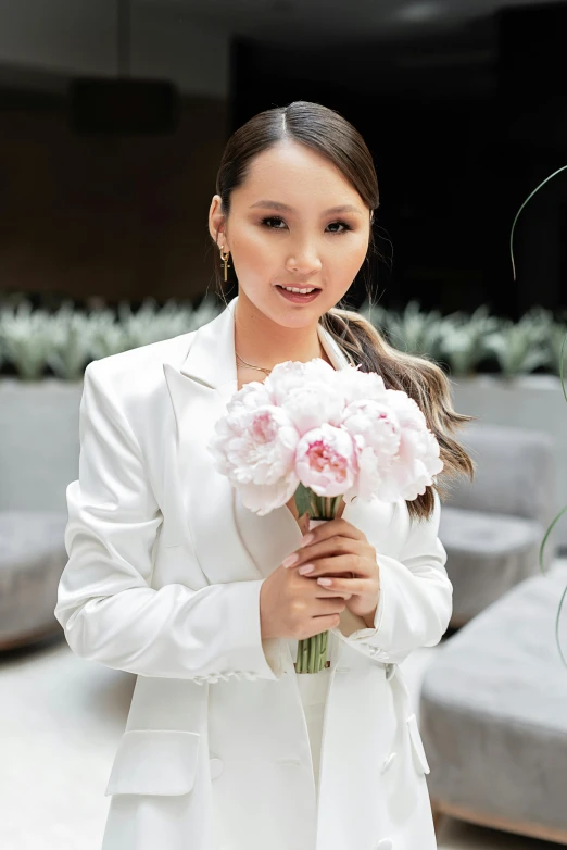 a woman in a white suit holding a bouquet of flowers, inspired by Ruth Jên, instagram, young asian woman, malaysian, formal wear, wearing jacket