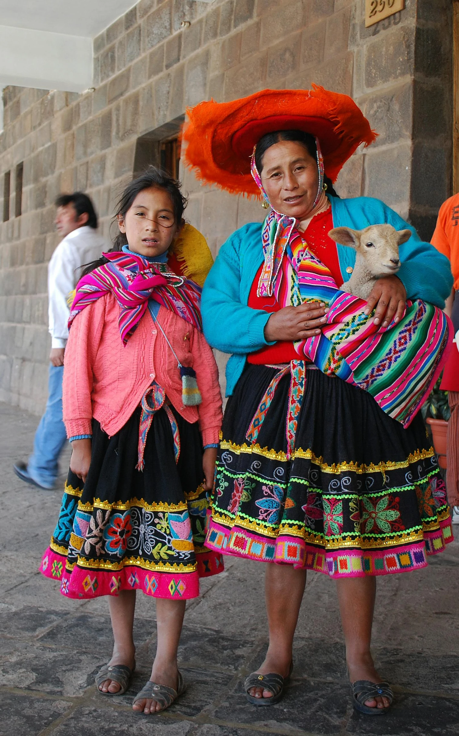 a group of people standing next to each other, by Peter Churcher, pexels contest winner, quito school, woman holding another woman, girl and a goat, textiles, square