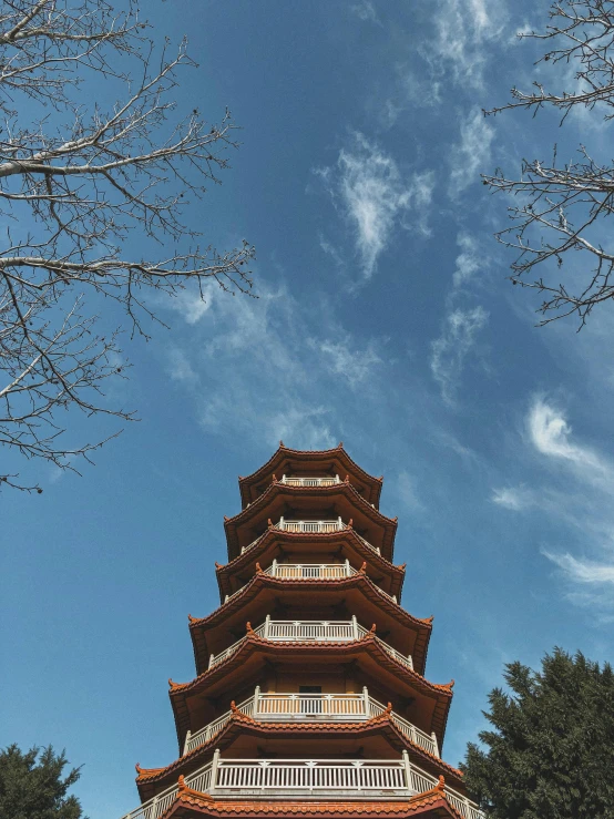 a tall pagoda sitting on top of a lush green field, inspired by An Zhengwen, pexels contest winner, cloisonnism, bottom view, architecture photo, photo on iphone, brown