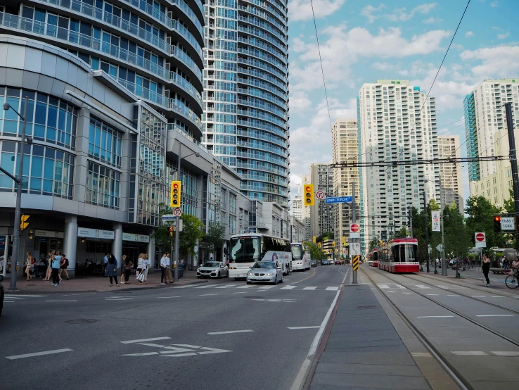 a city street filled with lots of traffic and tall buildings, a picture, canada, tram, near the beach, exterior photo