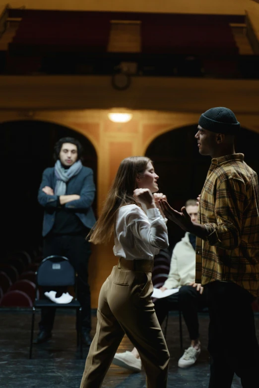 a group of people standing on top of a stage, a portrait, by Niko Henrichon, trending on unsplash, renaissance, 3 actors on stage, calmly conversing 8k, school class, [ theatrical ]