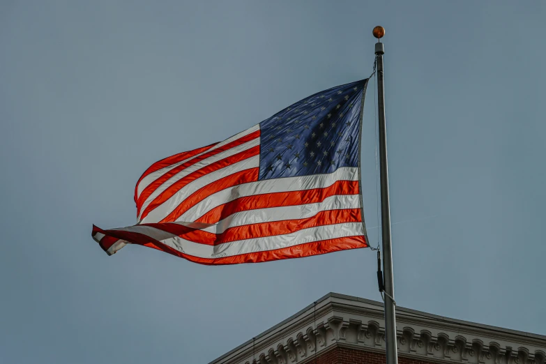 an american flag flying on top of a building, by Carey Morris, pexels, square, preserved historical, high quality image, leaked image